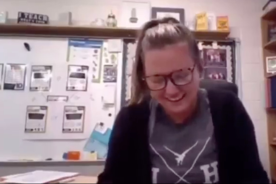 The teacher can't contain her laughter.