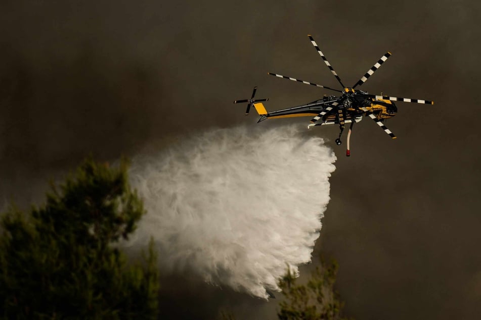 Firefighting helicopters collide in shock footage as multiple Greek wildfires rage