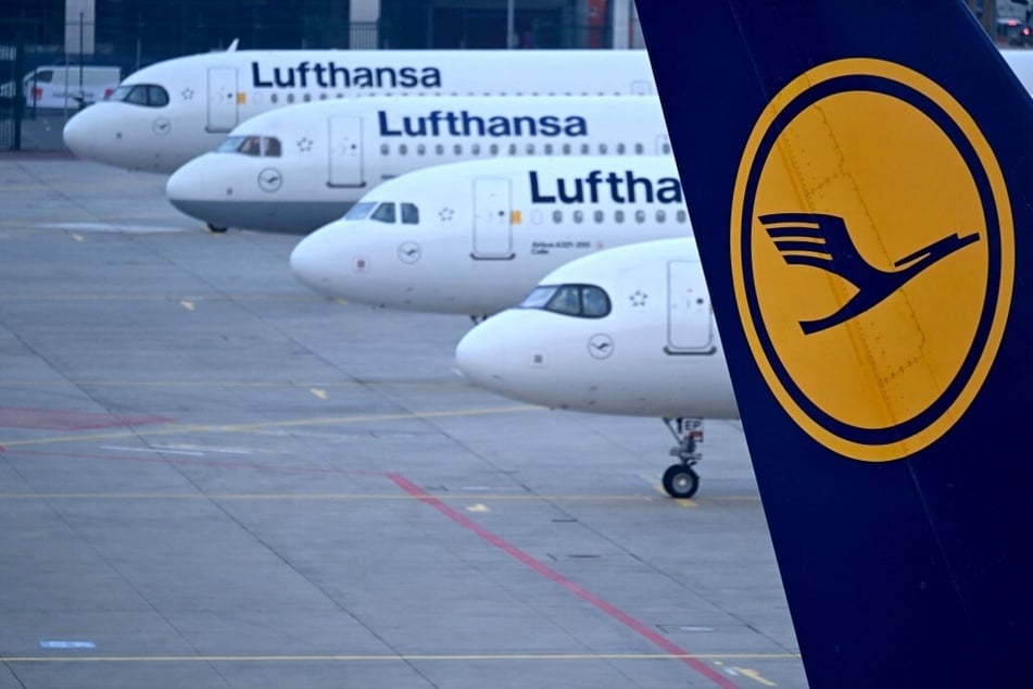 The logo of German airline Lufthansa can be seen on the vertical stabilizer of a plane standing with other aircraft at the airport in Frankfurt am Main.