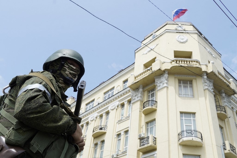 A member of the Wagner group stands guard in a street in the city of Rostov-on-Don on June 24, 2023.