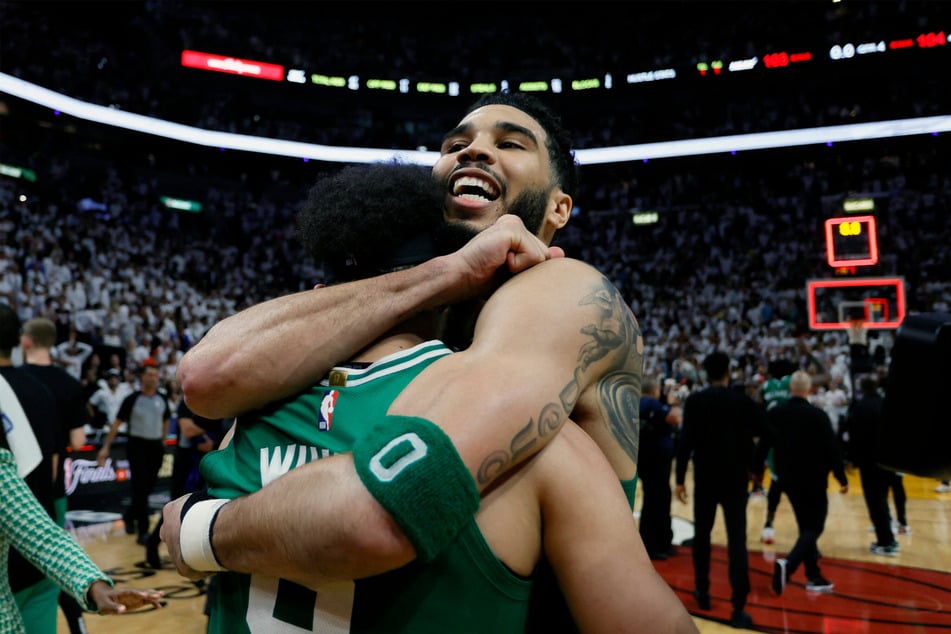 Boston Celtics guard Derrick White (r.) celebrated with forward Jayson Tatum after defeating the Miami Heat in Game 6 of the Eastern Conference Finals.