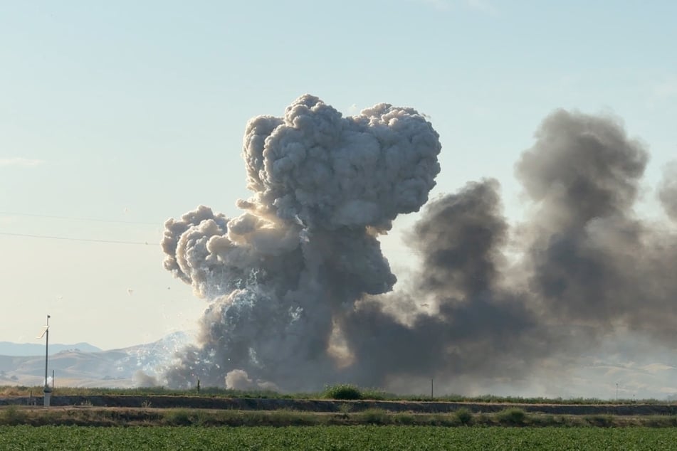 Clouds of smoke rise following explosions at a firework storage warehouse in Esparto, California.