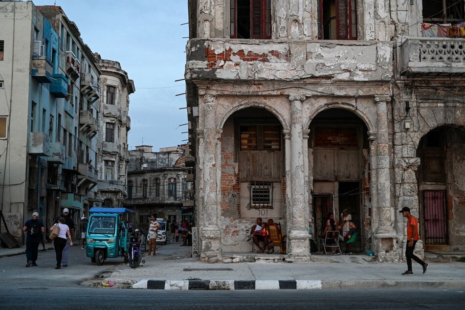 Cuban families gather outside their houses in Havana on July 6 during a nationwide blackout brought on by the US' brutal oil embargo.