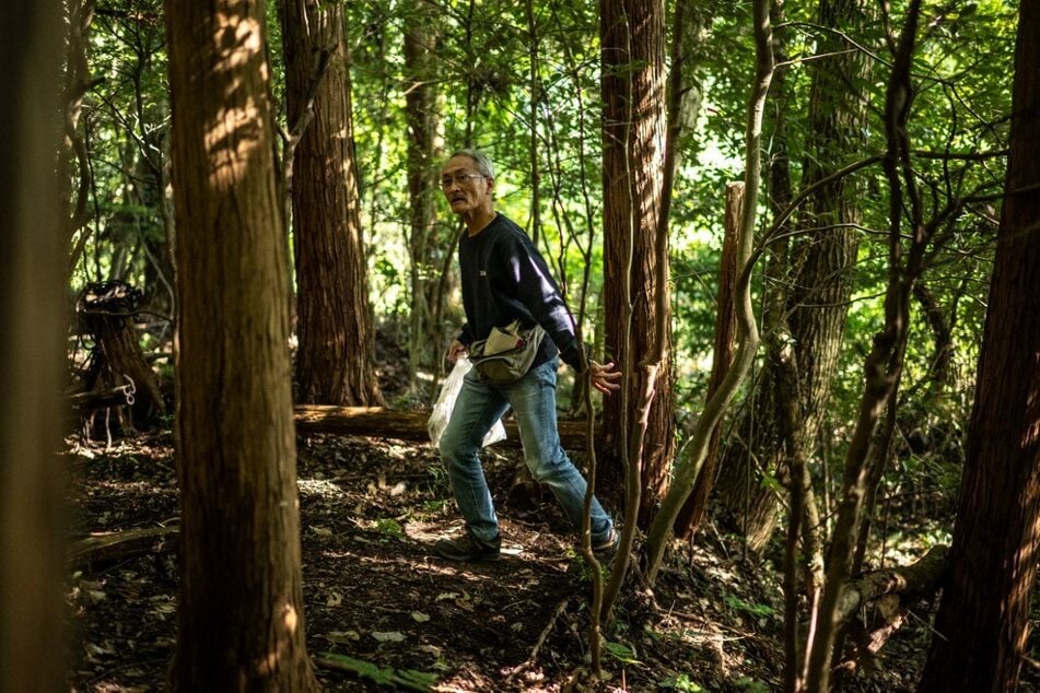 Japan's "poop master" Masana Izawa finds a spot to defecate in his forest in Sakuragawa, Ibaraki Prefecture.