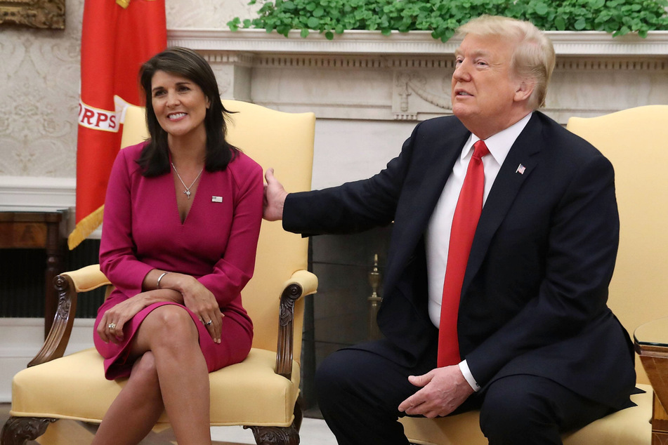 Donald Trump (r) accepting Nikki Haley's resignation as US Ambassador to the United Nations in the Oval Office on October 9, 2018.