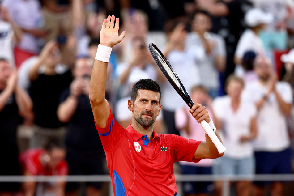 Novak Djokovic of Serbia celebrates after winning his match against Stefanos Tsitsipas of Greece at the Paris Olympics.