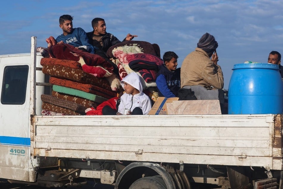 Palestinians arrive from Khan Younis in a truck loaded with their belongings, to a makeshift tent camp for displaced people in Rafah near the border with Egypt in the southern Gaza Strip, on January 24, 2024.