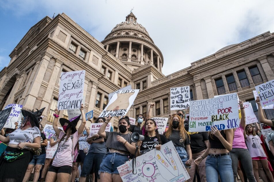 Women and allies rally outside the Texas Capitol to protest the state's six-week abortion ban.
