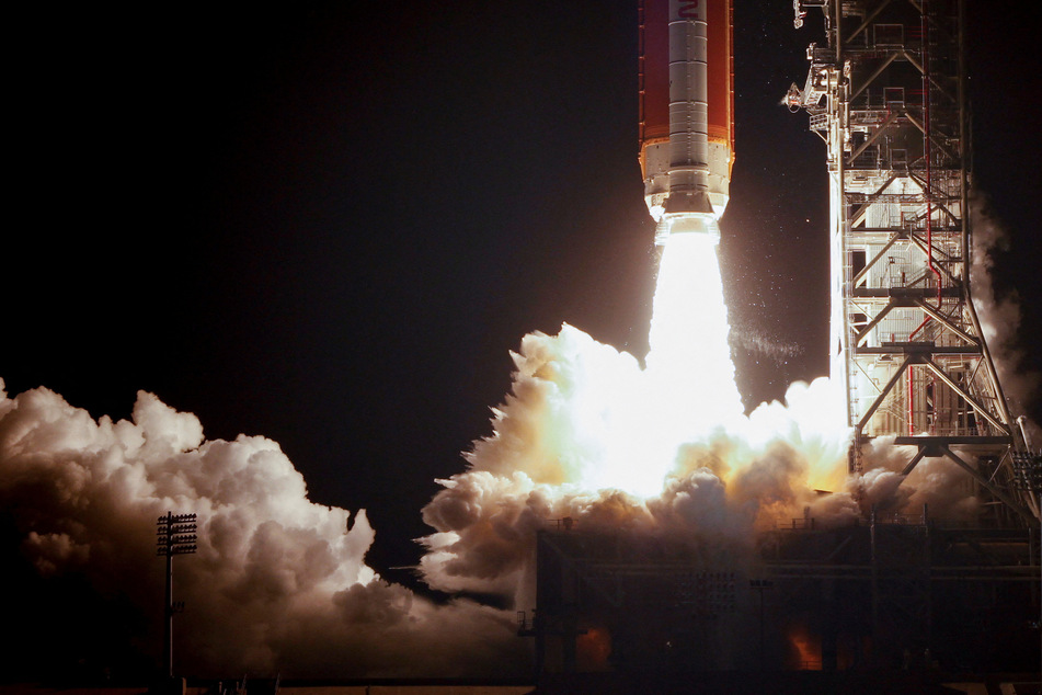 NASA's next-generation moon rocket, the Space Launch System rocket with the Orion crew capsule, lifts off from launch complex 39-B for the uncrewed Artemis I mission to the moon at Cape Canaveral, Florida.