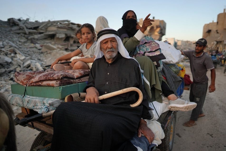 A displaced Palestinian family leaves east Khan Younis as Israel has continued to attack the city.