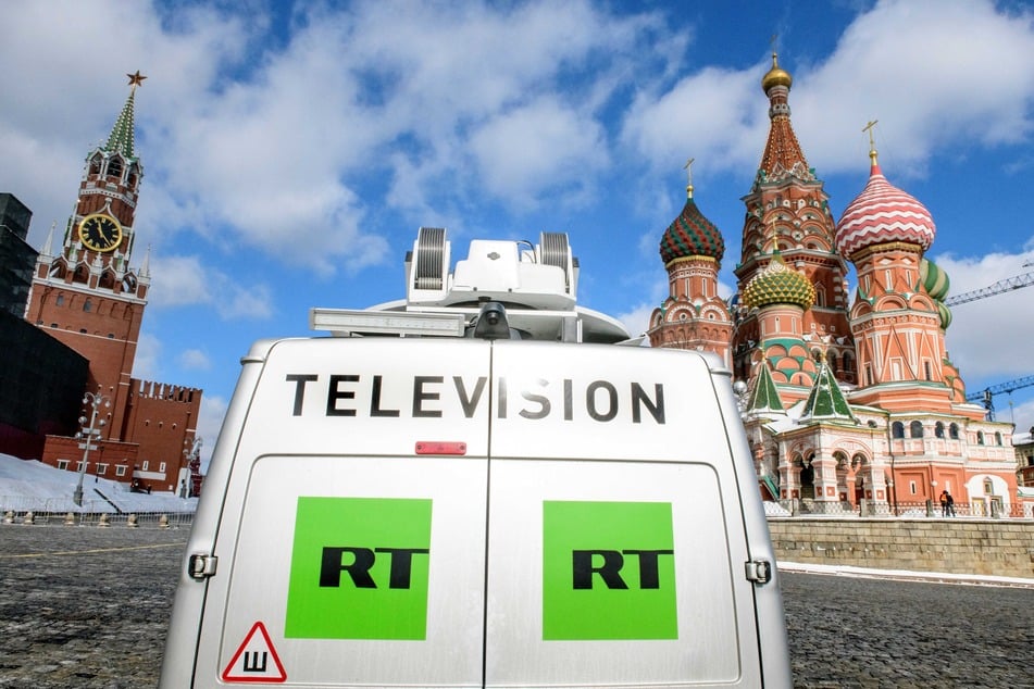 A Russia's state-controlled Russia Today (RT) television broadcast van is seen parked in front of St. Basil's Cathedral and the Kremlin next to Red Square in Moscow on March 16, 2018.