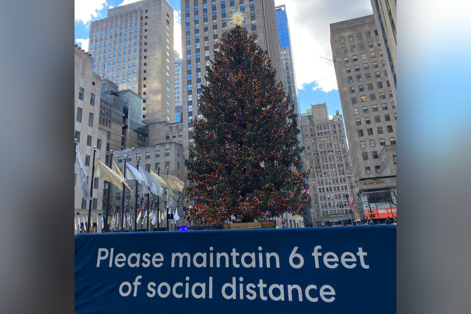 Last year, Rockefeller Center kept its few visitors socially distanced and barricaded from its famed Christmas tree (pictured). This year, tourists have already returned in droves for a much closer view.