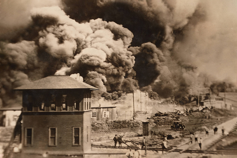 Smoke rises from burning buildings in the Greenwood District during the Tulsa Race Massacre of May 31-June 1, 1921.