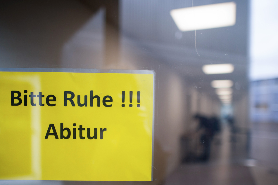 Ein Schild mit der Aufschrift "Bitte Ruhe!!! Abitur" hängt in einem Gymnasium.