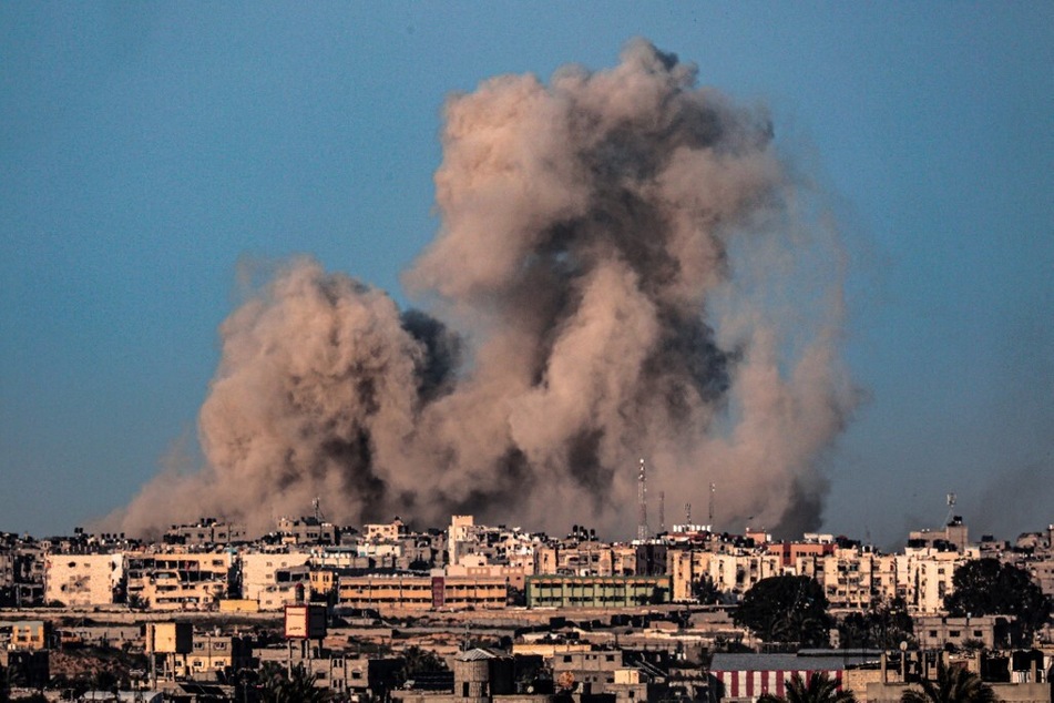 A picture taken from Rafah in the southern Gaza Strip shows smoke billowing during Israeli bombardment of Khan Younis.