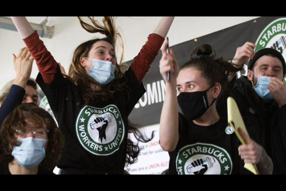 Starbucks workers in Buffalo celebrate winning the first unionized store in the US in December 2021.