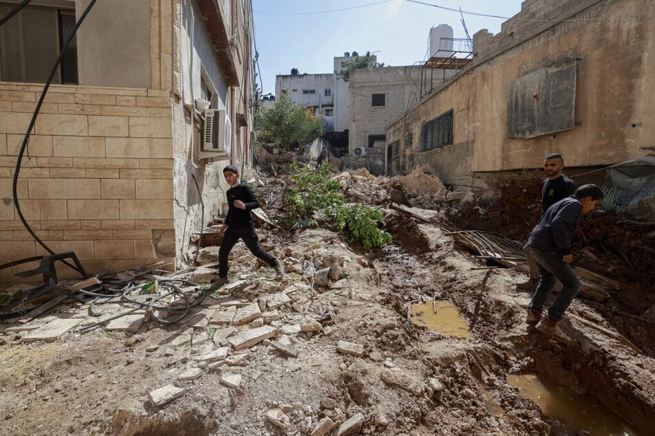 Palestinians inspect the destruction following an Israeli raid in the eastern neighborhood of Jenin city in the Israeli-occupied West Bank.