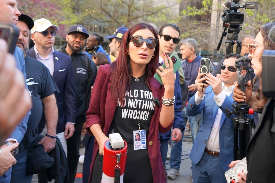 Lara Loomer addressing a crowd with a bullhorn while outside of Donald Trump's criminal hush money trial in New York City on April 15, 2024.