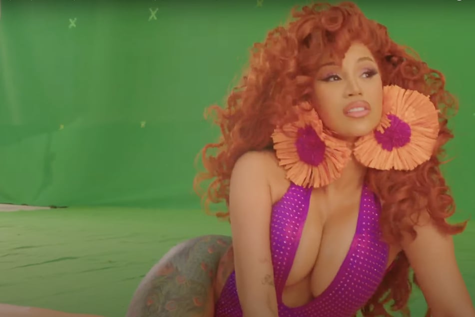 Cardi B revealed new footage of the filming of her Bongos music video.