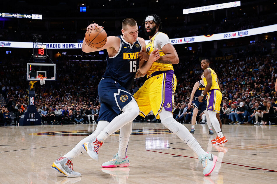 Denver Nuggets center Nikola Jokic drives to the net against Los Angeles Lakers forward Anthony Davis in the fourth quarter at Ball Arena.