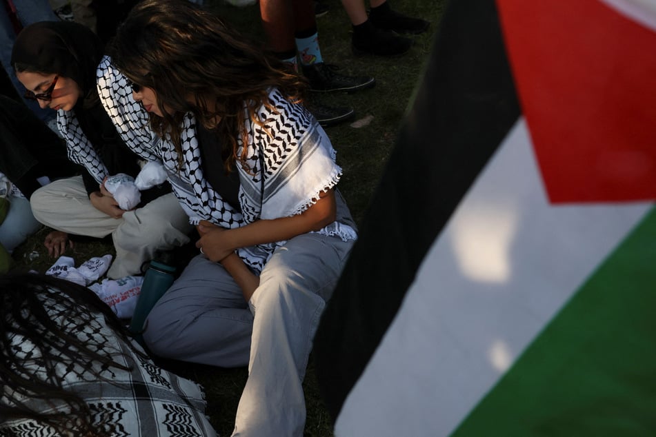 Protesters in keffiyehs join Gaza solidarity demonstrations in Union Park during the Democratic National Convention in Chicago, Illinois.