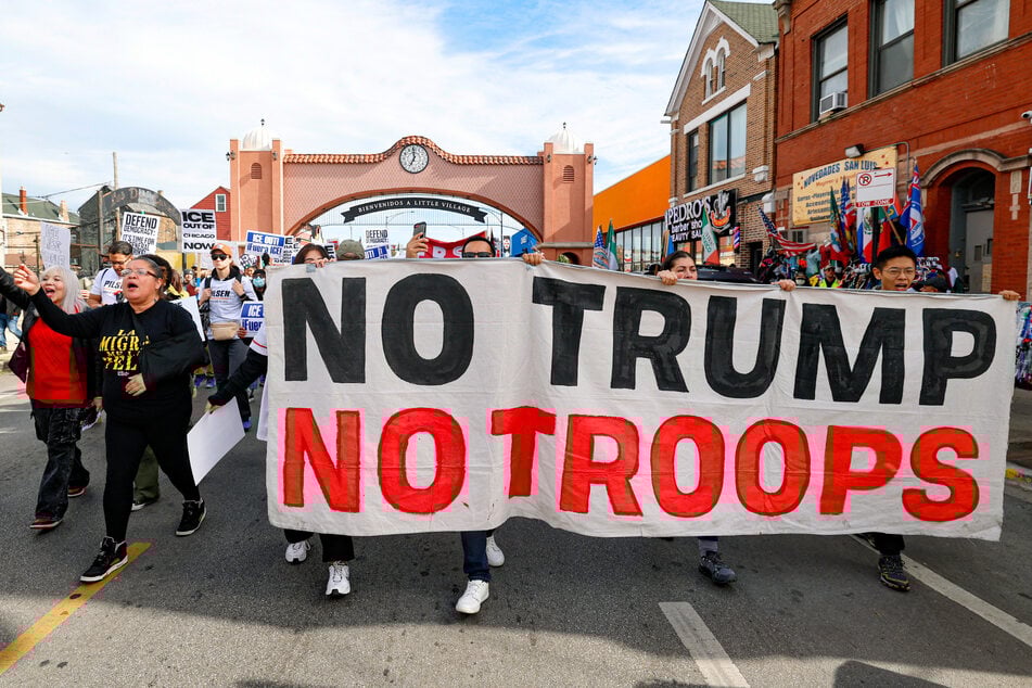 Protesters march against Immigration and Customs Enforcement during the "ICE and DHS Out of Little Village" demonstration in Chicago, Illinois, on October 25, 2025.