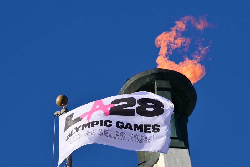 The LA28 Olympic cauldron is lit during a ceremonial lighting at the Memorial Coliseum in Los Angeles on January 13, 2026.