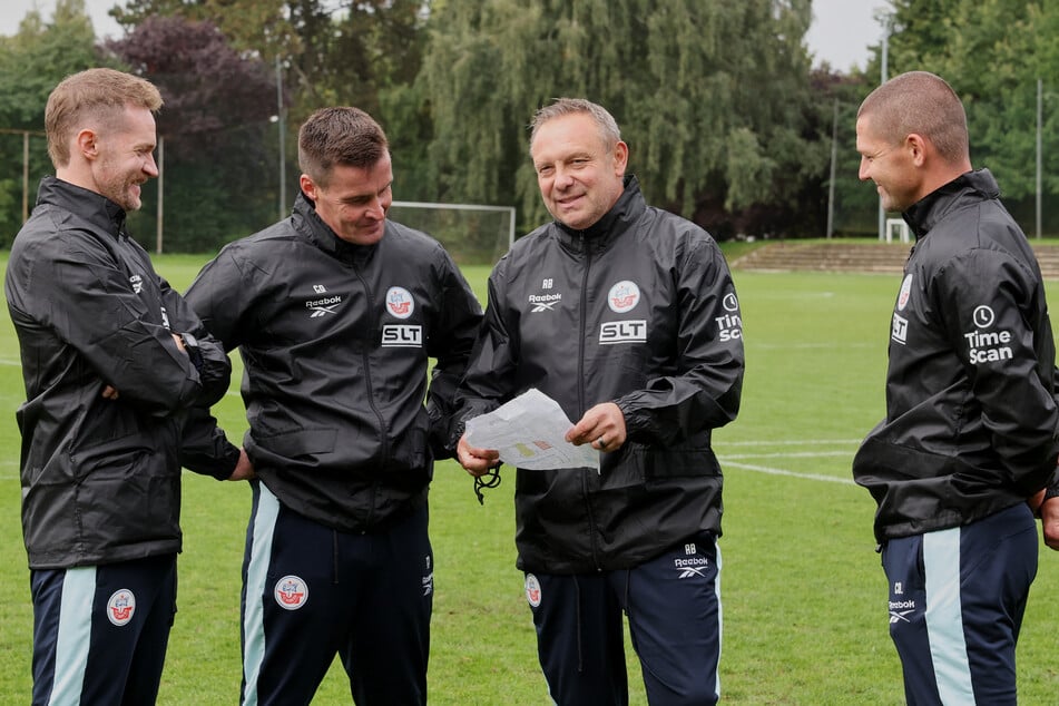 André Breitenreiter (52, 3.v.l.) berät sich mit seinem Trainerteam.