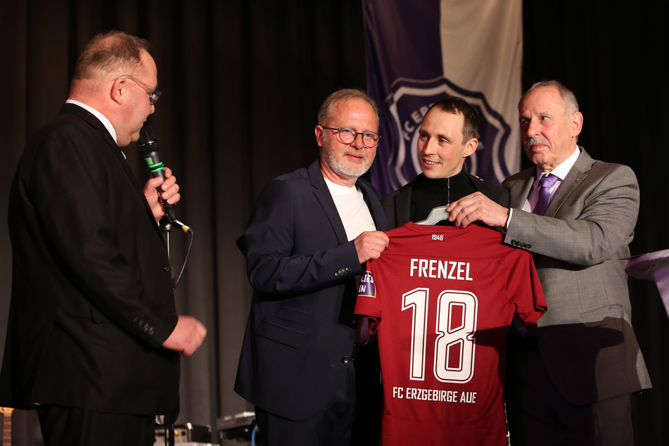 Eric Frenzel (34, 2.v.r.) bekam von FCE-Präsident Roland Frötschner (r.) und dem Vorsitzenden des Förderkreises, Manfred Jahn (2.v.l.), das FCE-Trikot mit der Rückennummer 18 geschenkt. Ganz links: Ronny Maiwald, der Moderator des Abends.
