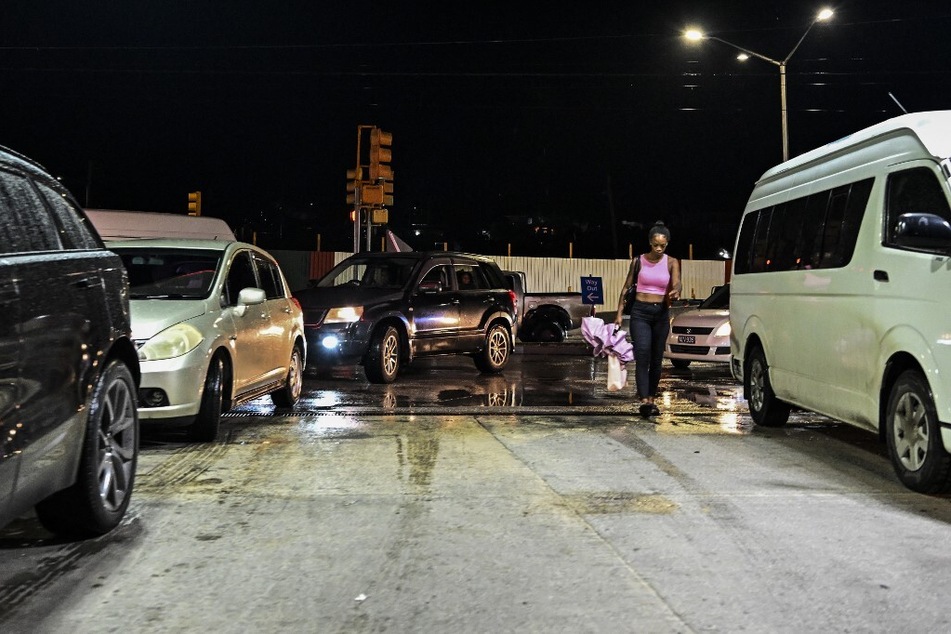 Car line up at a gas station before Hurricane Beryl lands in Bridgetown, Barbados.