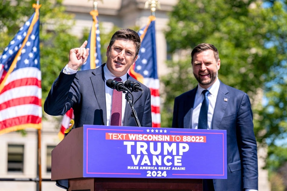 Wisconsin Representative Bryan Steil (L) addresses an audience alongside Republican Vice Presidential candidate JD Vance (R) during a campaign rally in Kenosha, Wisconsin on August 20, 2024.