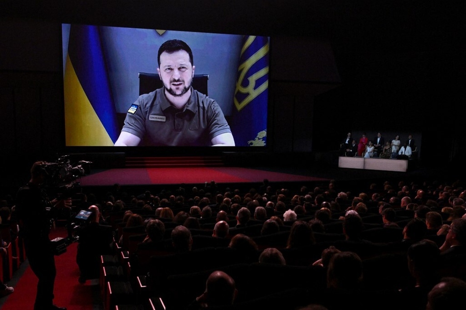 Ukrainian President Volodymyr Zelensky addresses guests during the Opening Ceremony of the 75th edition of the Cannes Film Festival on May 17, 2022.