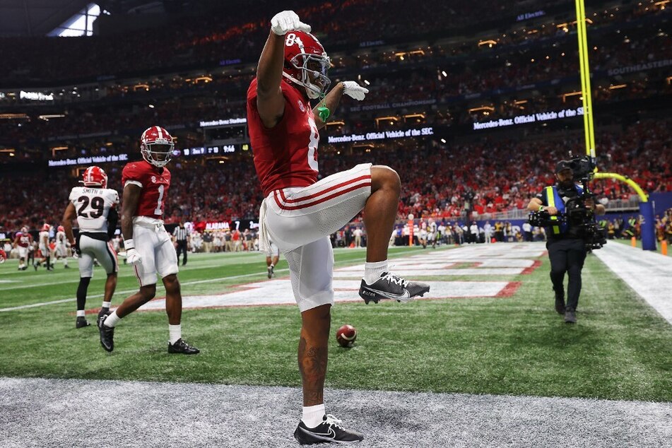 John Metchie III of the Alabama Crimson Tide reacts after scoring a touchdown in the second quarter of the SEC Championship game against the Georgia Bulldogs.