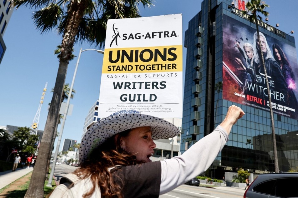 SAG-AFTRA member Christine Robert pickets in solidarity with striking Writers Guild of America workers outside the Netflix offices in Los Angeles, California, on July 12, 2023.