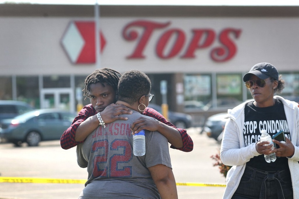 People gather at a memorial victims of a white supremacist shooting that took place at a Tops supermarket in Buffalo, New York, in May 2022.
