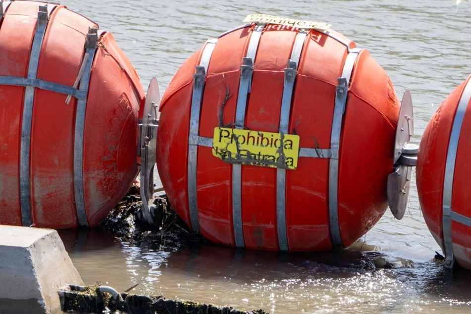 The buoys were installed in the river near Eagle Pass, Texas, in July on the instructions of Governor Greg Abbott, along with large razor-wire barriers on shore.