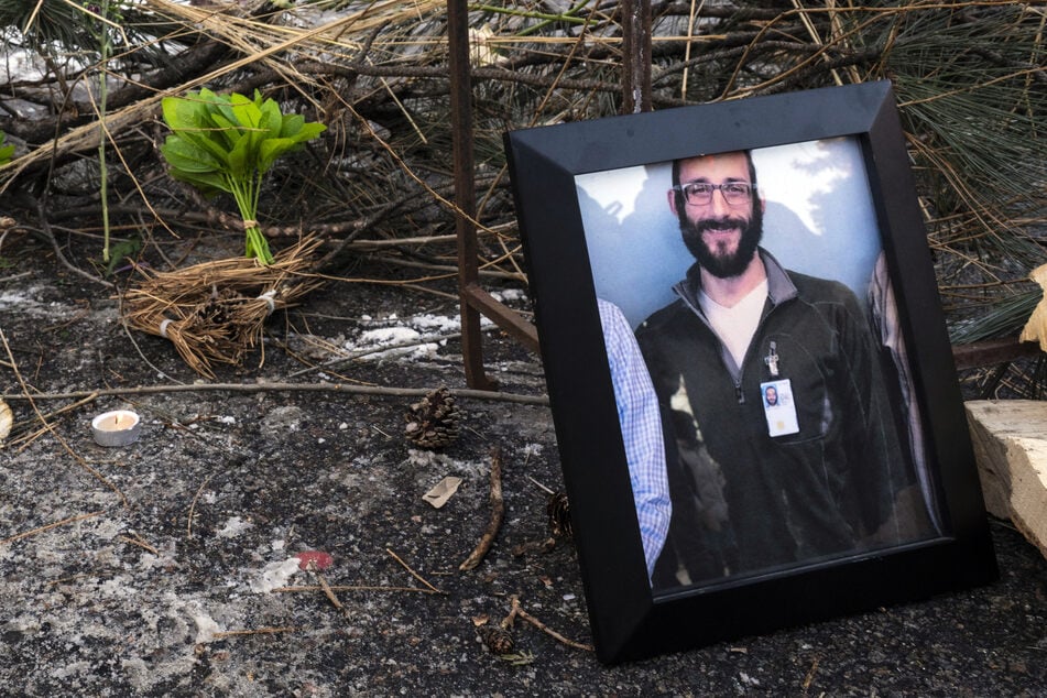 A photograph of 37-year-old Alex Pretti can be seen at a makeshift memorial in the area where he was shot dead by federal immigration agents earlier in the day in Minneapolis, Minnesota, on Saturday.