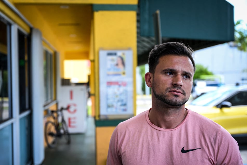 Denis Caldeira says he feels like he is in legal "limbo" during an interview outside a Venzuelan food mart in Doral, Florida, on May 20, 2025.
