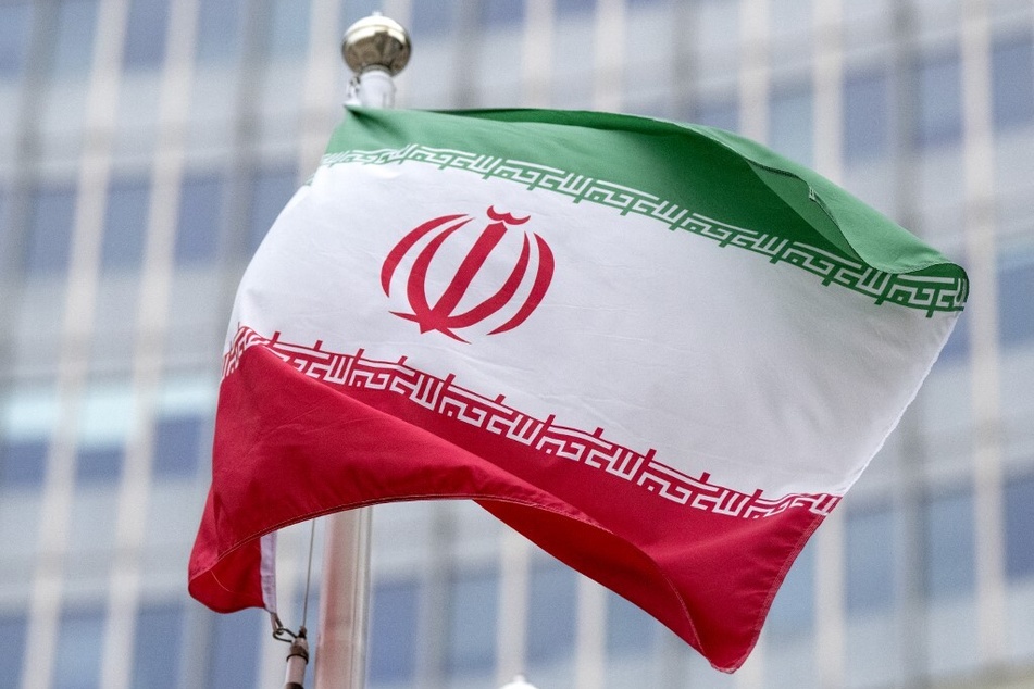 The flag of Iran flutters outside of the International Atomic Energy Agency's headquarters in Vienna, Austria.