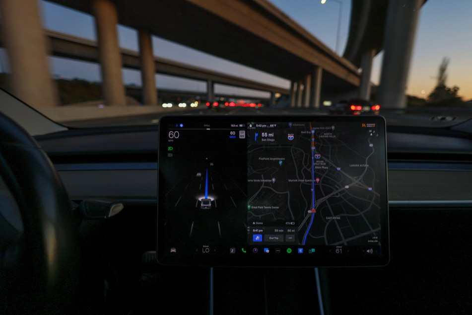 A Tesla Model 3 vehicle is shown driving using Full Self Driving (FSD) beta software on a California highway near Irvine.