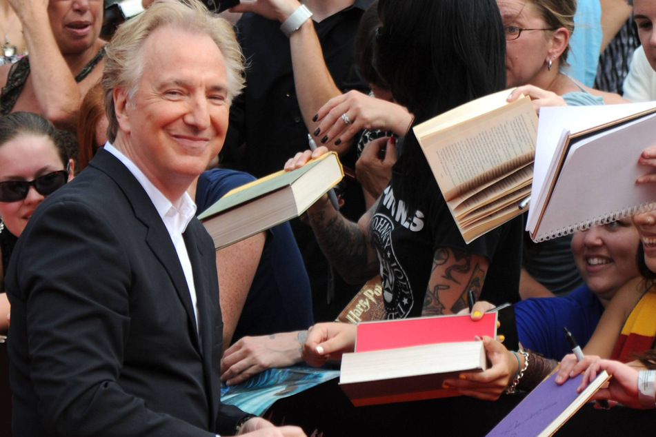 Alan Rickman greets fans at the premiere of Harry Potter and the Deathly Hallows Part Two.