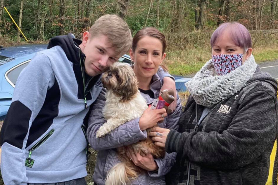 Magdalena Klubczuk (c) holds Roxy in her arms and her son nuzzles up to the old pooch.