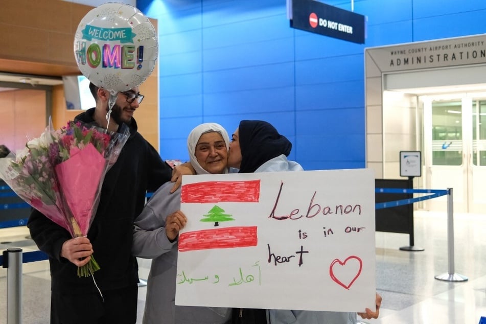 Micho Assi (r.) and her son (l.) welcome her parents arriving from Lebanon at Detroit Metropolitan Wayne County Airport in Michigan.