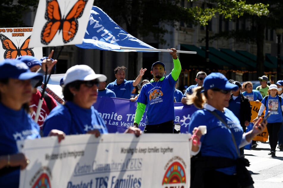 Activists and citizens with TPS status protest to demand protection.