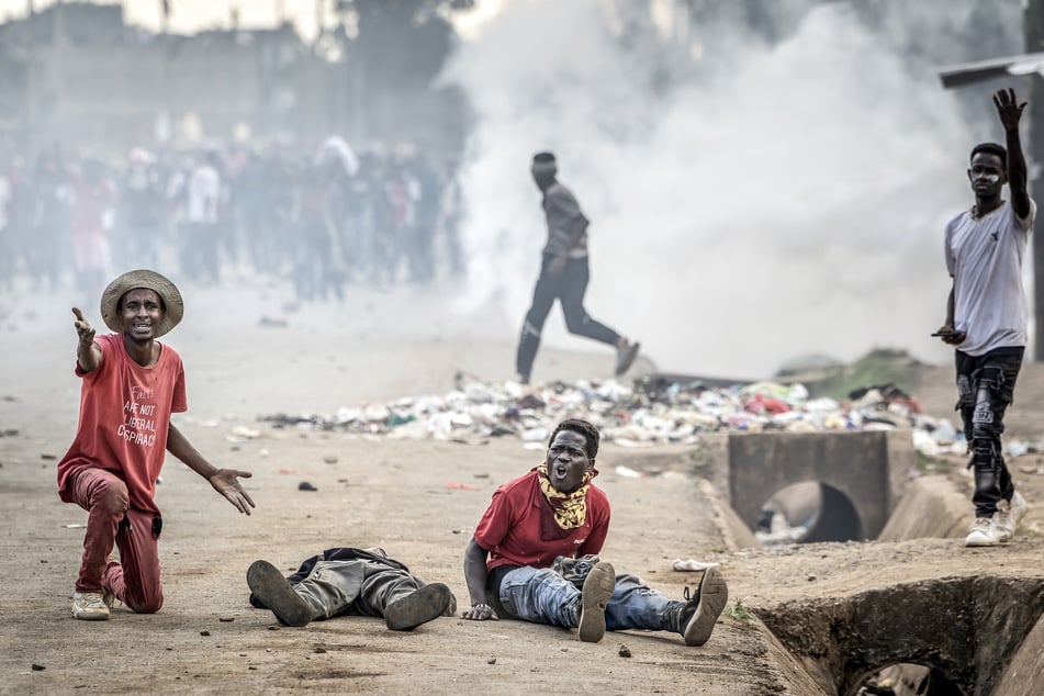 People seek for help next to a protester seriously injured by Kenyan police during a demonstration against a US Ebola quarantine center on June 9, 2026.