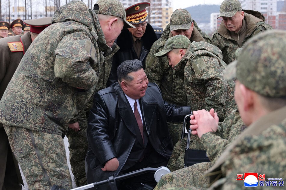 North Korean leader Kim Jong Un welcomes soldiers from the Korean People's Army's 528th Regiment of Engineers, which returned from an overseas deployment in Russia's Kursk region during the war with Ukraine, on December 12, 2025.