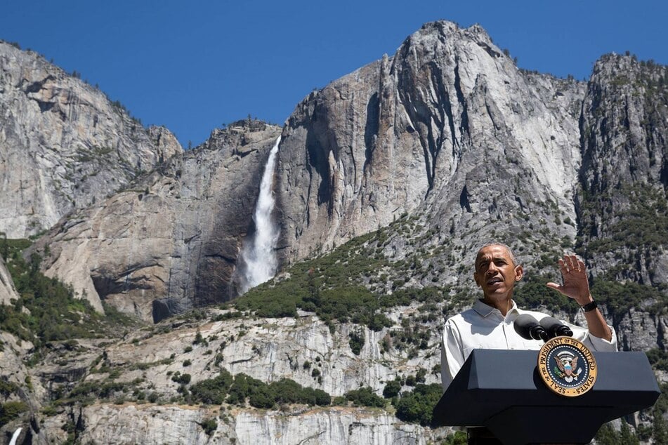 Former US president Barack Obama addressing the media in front of the 2,400-foot Yosemite Falls in Yosemite National Park, California, July 19, 2016.