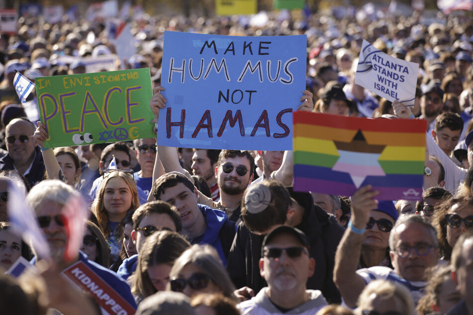 Marchers hold signs at the March for Israel on the National Mall in Washington DC on Tuesday.