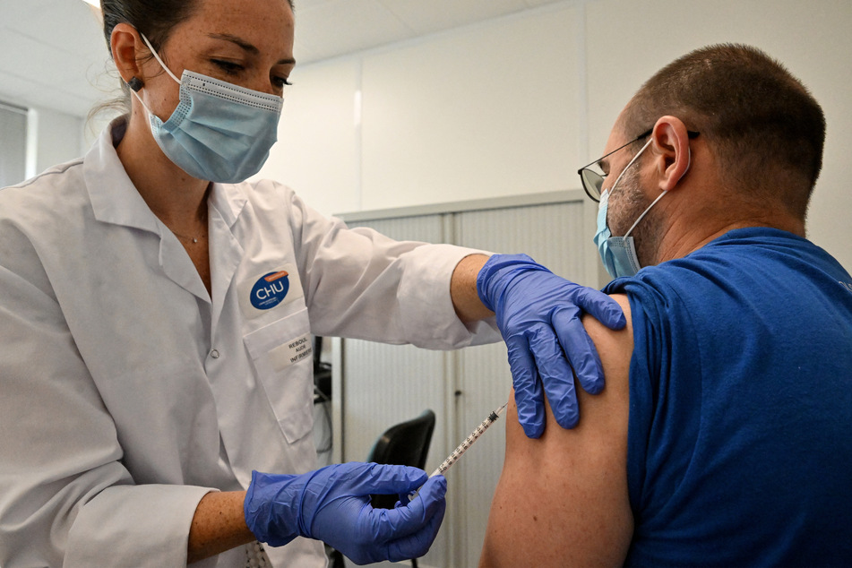 A nurse vaccinates a patient against monkeypox at a Centre gratuit d'information, de dépistage et de diagnostic (CeGIDD) in Montpellier, southern France on August 23, 2022.