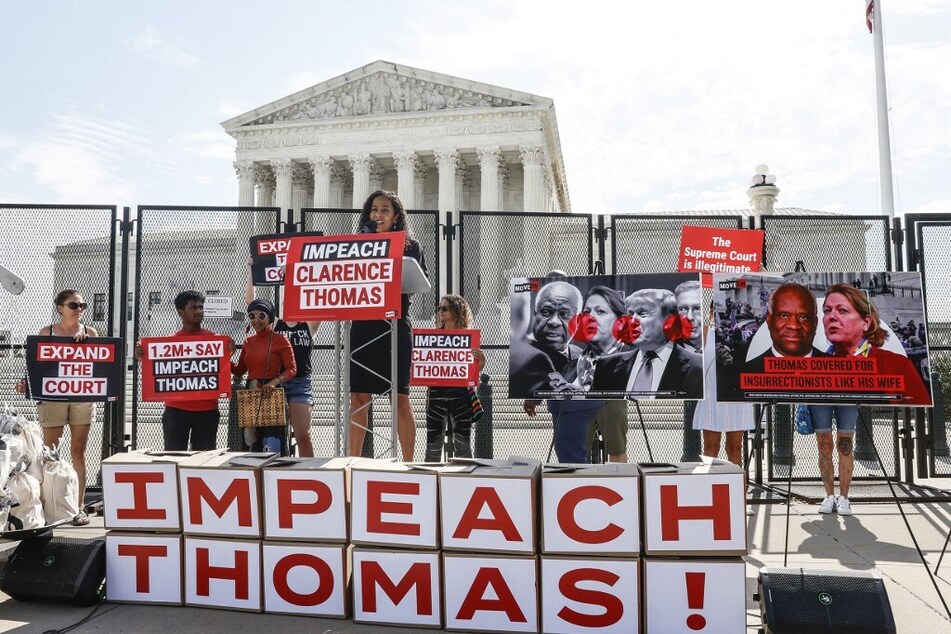 Protesters rally outside the US Supreme Court demanding Justice Clarence Thomas' impeachment.